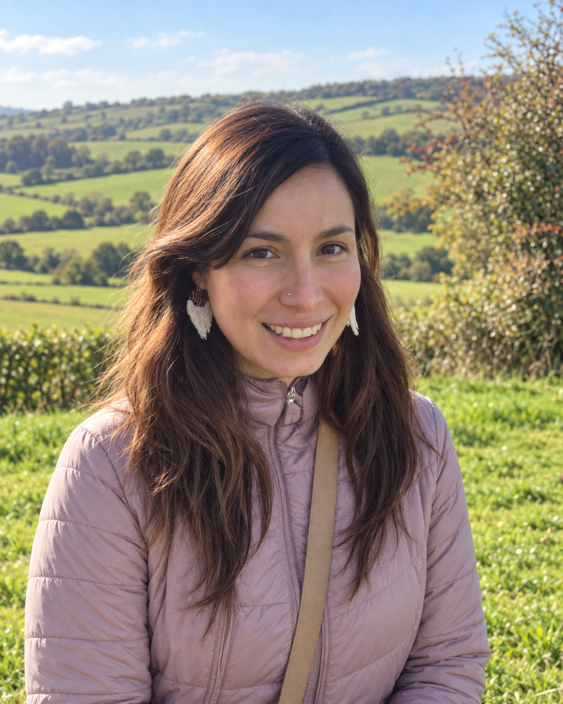 Mariana smiling outdoors in the countryside